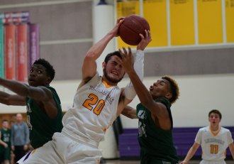 Kent Lambert aggressively goes for the basket against El Diamante in Thursday night's game.